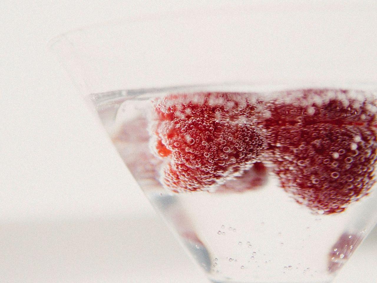 red liquid in clear drinking glass