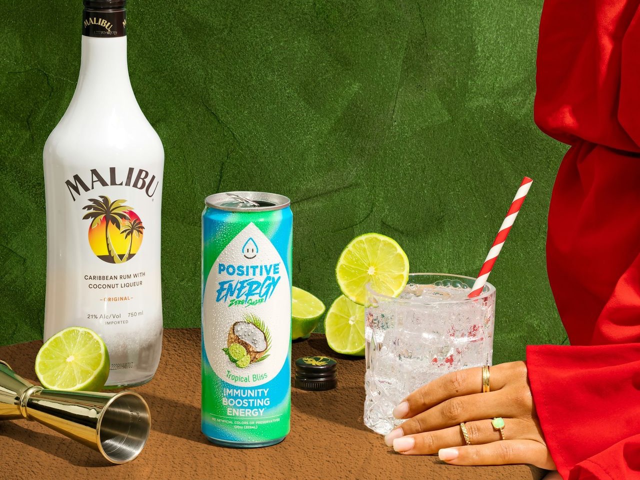 a woman sitting at a table with a bottle of alcohol and a glass